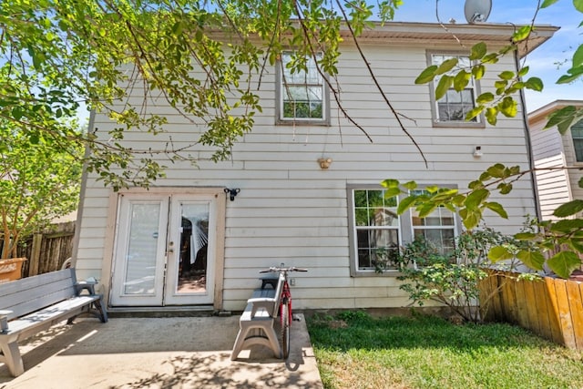 rear view of property featuring a patio area and fence