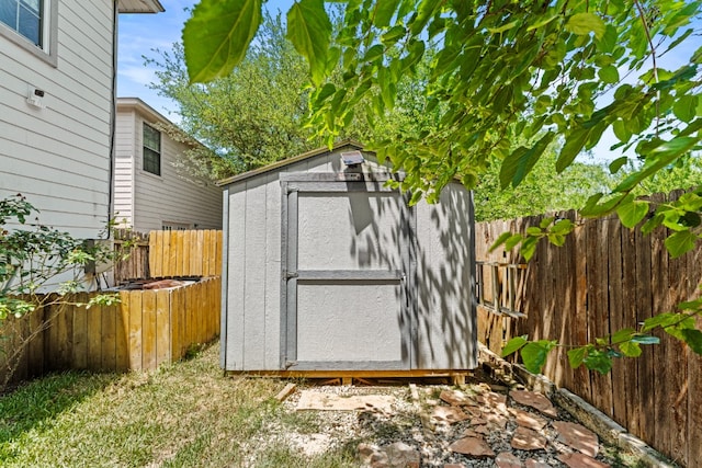view of shed with a fenced backyard