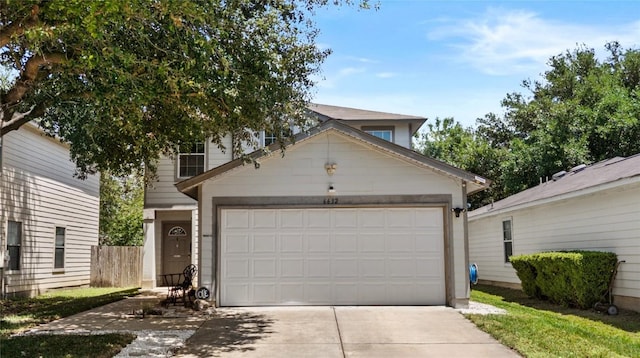 traditional-style home with driveway, an outdoor structure, and a garage