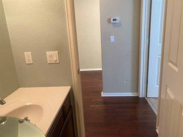 721 Independence Creek Ln, Georgetown, TX 78633 - bathroom with vanity, baseboards, and wood finished floors