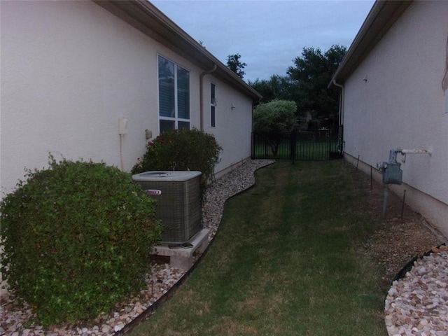 721 Independence Creek Ln, Georgetown, TX 78633 - view of property exterior featuring a yard, stucco siding, fence, and central AC