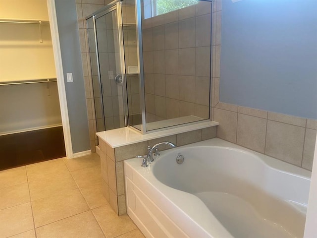 721 Independence Creek Ln, Georgetown, TX 78633 - bathroom with tile patterned flooring, a garden tub, tiled shower, and a walk in closet