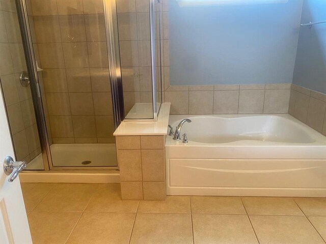 721 Independence Creek Ln, Georgetown, TX 78633 - full bath featuring tile patterned flooring, a garden tub, and a shower stall