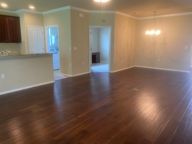 721 Independence Creek Ln, Georgetown, TX 78633 - unfurnished living room with recessed lighting, an inviting chandelier, crown molding, dark wood-style floors, and baseboards