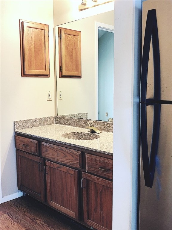 2210 Pearl St Unit 304, Austin, TX 78705 - bathroom featuring baseboards, vanity, and wood finished floors