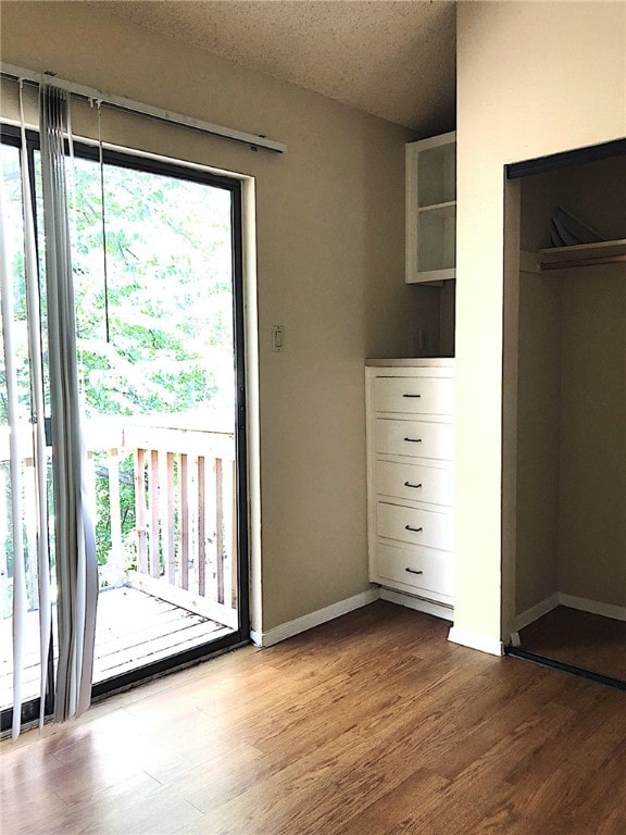 2210 Pearl St Unit 304, Austin, TX 78705 - entryway with baseboards and wood finished floors