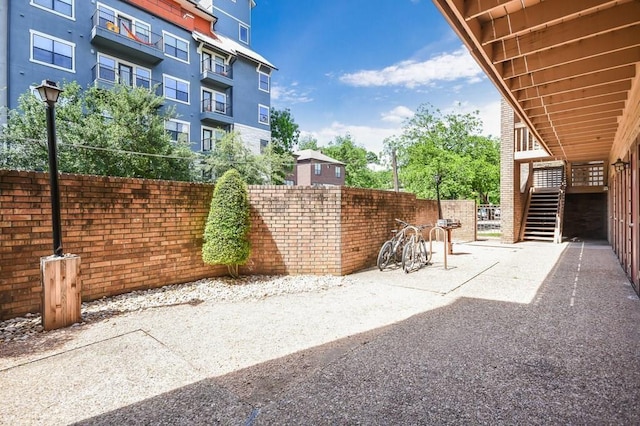 2210 Pearl St Unit 304, Austin, TX 78705 - view of patio / terrace featuring fence and stairs