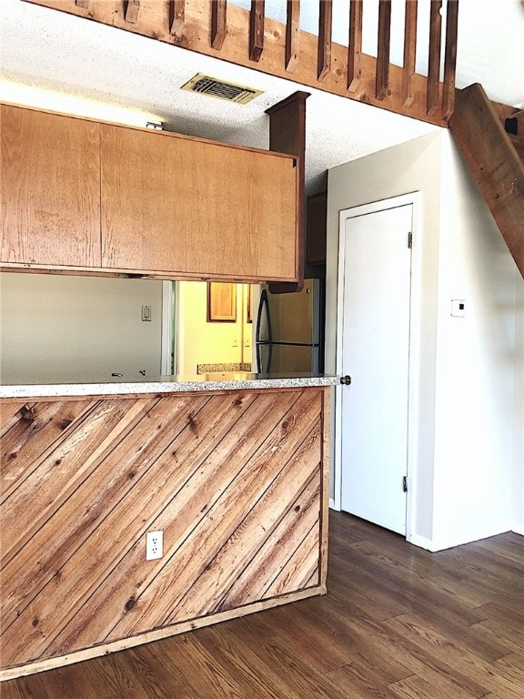 2210 Pearl St Unit 304, Austin, TX 78705 - kitchen featuring freestanding refrigerator, dark wood-type flooring, baseboards, and visible vents