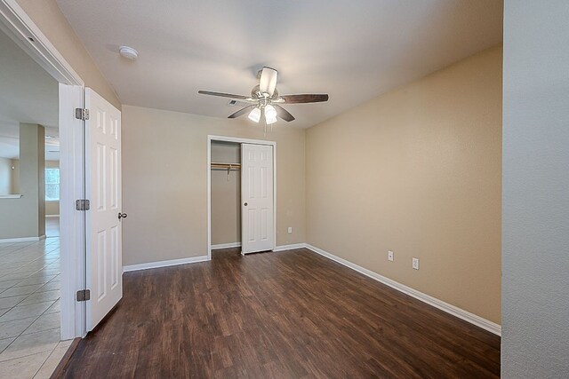 7725 Buckmeadow Dr, Georgetown, TX 78628 - unfurnished bedroom with baseboards, a closet, a ceiling fan, and wood finished floors