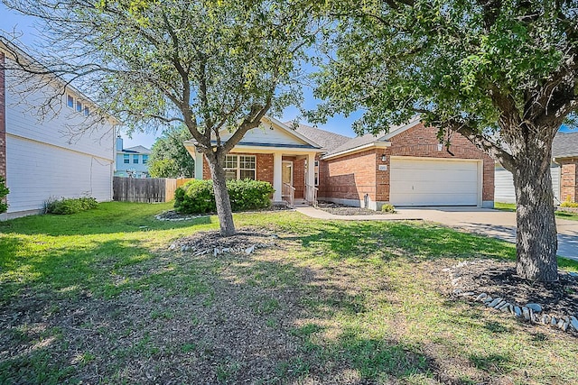 7725 Buckmeadow Dr, Georgetown, TX 78628 - single story home featuring brick siding, fence, a garage, concrete driveway, and a front lawn