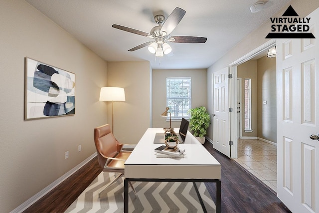 7725 Buckmeadow Dr, Georgetown, TX 78628 - office area with dark wood-style flooring, a ceiling fan, and baseboards