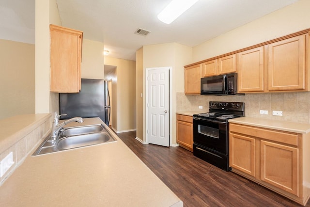 13605 James Garfield St, Manor, TX 78653 - kitchen featuring a sink, black appliances, visible vents, dark wood-style floors, and light brown cabinets