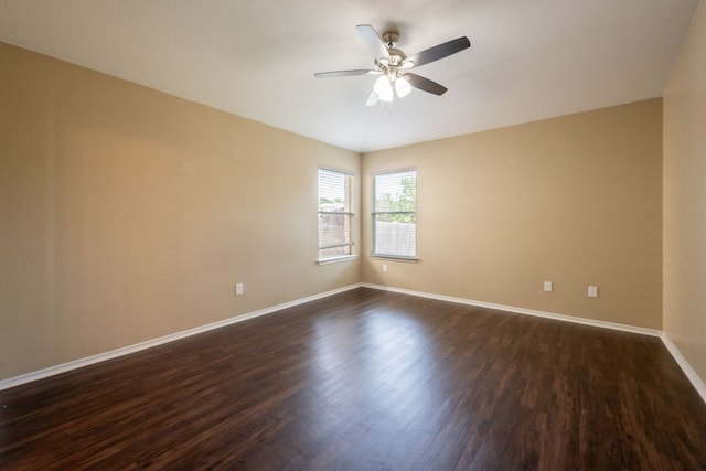 13605 James Garfield St, Manor, TX 78653 - empty room with dark wood-style floors, baseboards, and a ceiling fan