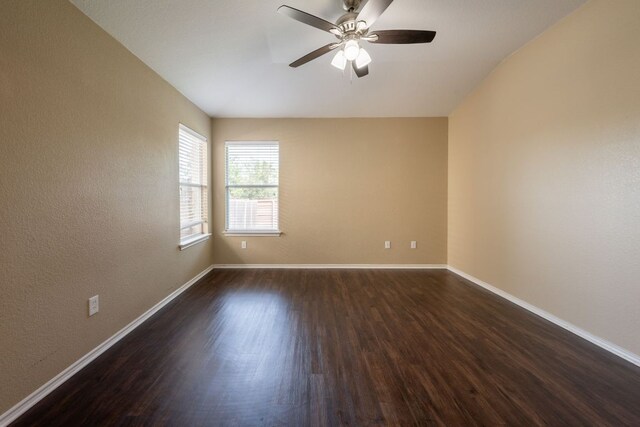 13605 James Garfield St, Manor, TX 78653 - unfurnished room with dark wood-style flooring, baseboards, and ceiling fan