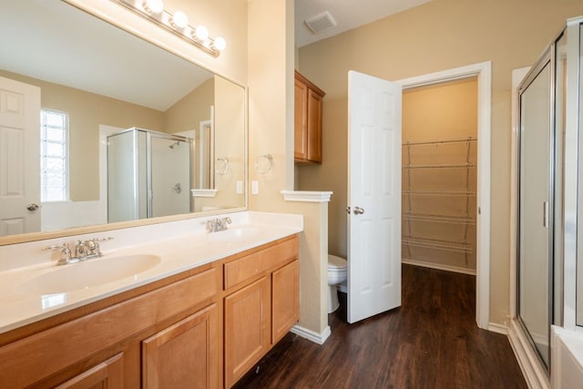 13605 James Garfield St, Manor, TX 78653 - full bathroom with a shower stall, toilet, a sink, and wood finished floors