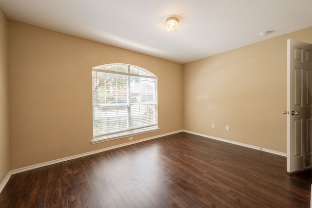 13605 James Garfield St, Manor, TX 78653 - spare room featuring baseboards and dark wood-type flooring