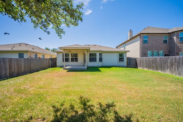13605 James Garfield St, Manor, TX 78653 - back of property with a yard, a patio area, and a fenced backyard