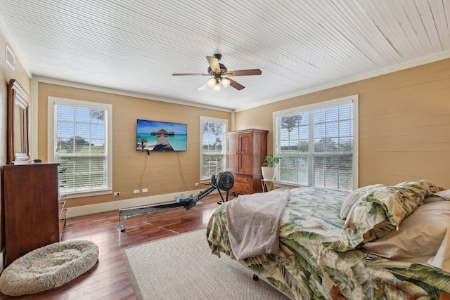 1200 County Road 211, Giddings, TX 78942 - bedroom with multiple windows, a ceiling fan, ornamental molding, and hardwood / wood-style flooring