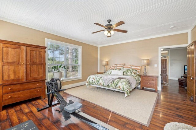 1200 County Road 211, Giddings, TX 78942 - bedroom with dark wood-style flooring, baseboards, and ceiling fan