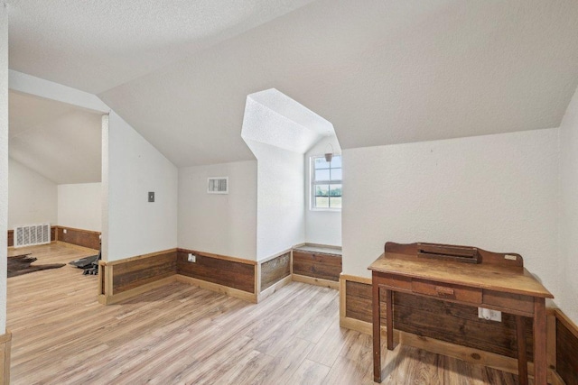 1200 County Road 211, Giddings, TX 78942 - bonus room with light wood-style floors, lofted ceiling, wainscoting, and wood walls