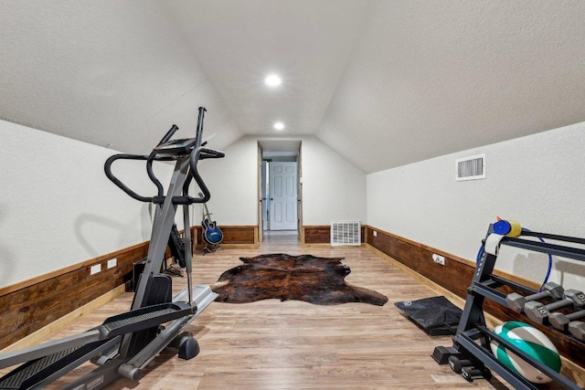 1200 County Road 211, Giddings, TX 78942 - workout room featuring a wainscoted wall, visible vents, wood finished floors, and wooden walls