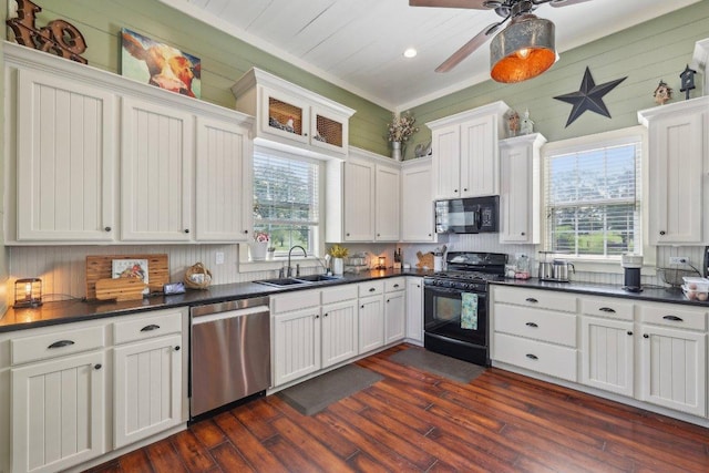 1200 County Road 211, Giddings, TX 78942 - kitchen featuring a sink, dark countertops, black appliances, and plenty of natural light