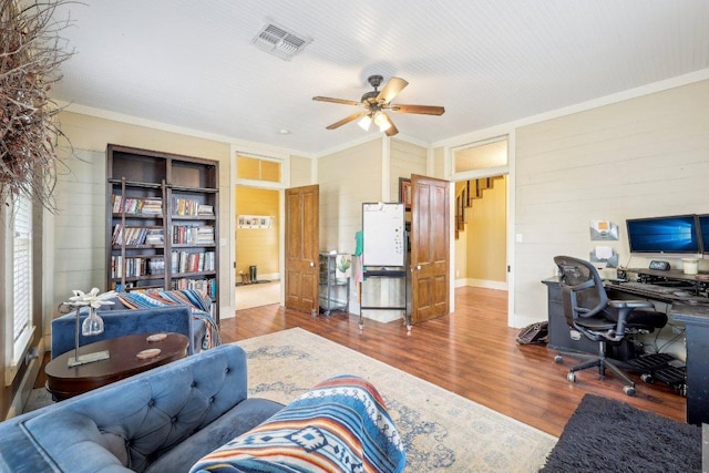 1200 County Road 211, Giddings, TX 78942 - office with a ceiling fan, visible vents, wood walls, crown molding, and wood finished floors