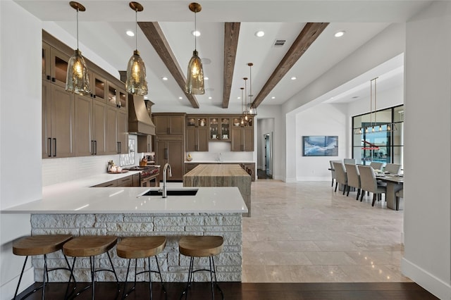 5609 Laceback Ter, Austin, TX 78738 - kitchen featuring premium range hood, beamed ceiling, a peninsula, tasteful backsplash, and recessed lighting
