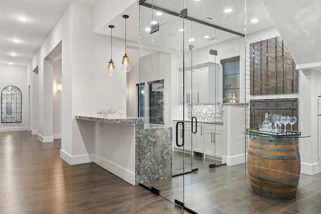 5609 Laceback Ter, Austin, TX 78738 - bar featuring dark wood-style floors, backsplash, recessed lighting, and hanging light fixtures