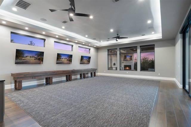 5609 Laceback Ter, Austin, TX 78738 - home theater with ceiling fan, a raised ceiling, dark wood finished floors, and recessed lighting