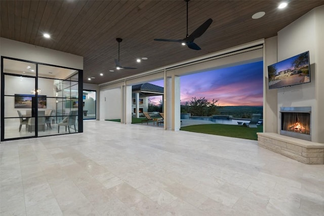 5609 Laceback Ter, Austin, TX 78738 - view of patio / terrace with a lit fireplace and a ceiling fan