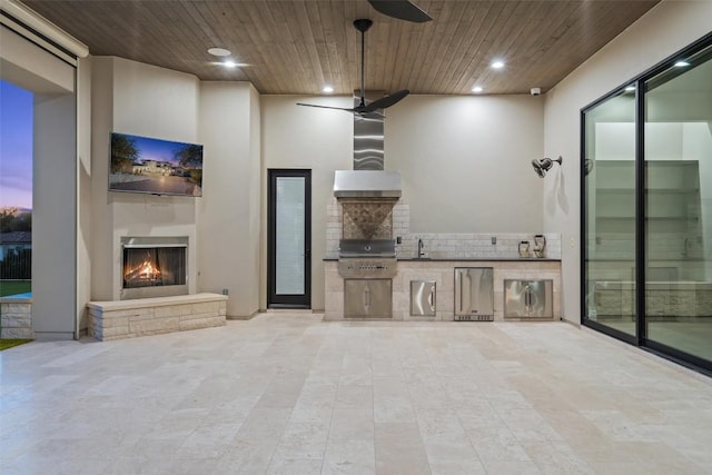 5609 Laceback Ter, Austin, TX 78738 - unfurnished living room featuring a lit fireplace, wood ceiling, recessed lighting, ceiling fan, and light tile patterned flooring