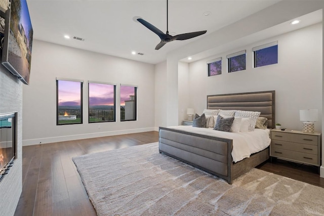 5609 Laceback Ter, Austin, TX 78738 - bedroom featuring wood finished floors, recessed lighting, a large fireplace, and ceiling fan