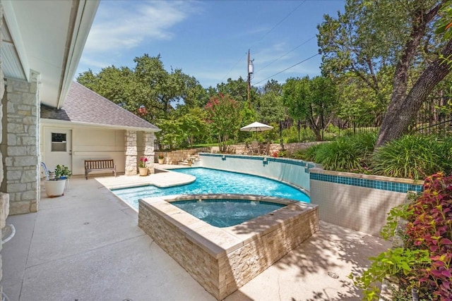 view of swimming pool with an in ground hot tub, a fenced in pool, and a patio