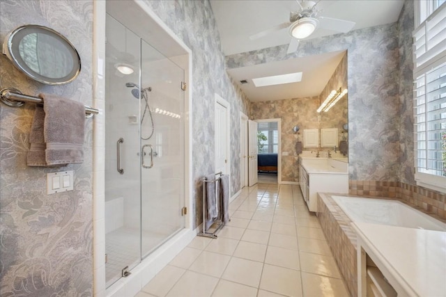 bathroom featuring wallpapered walls, a stall shower, tile patterned flooring, and a skylight