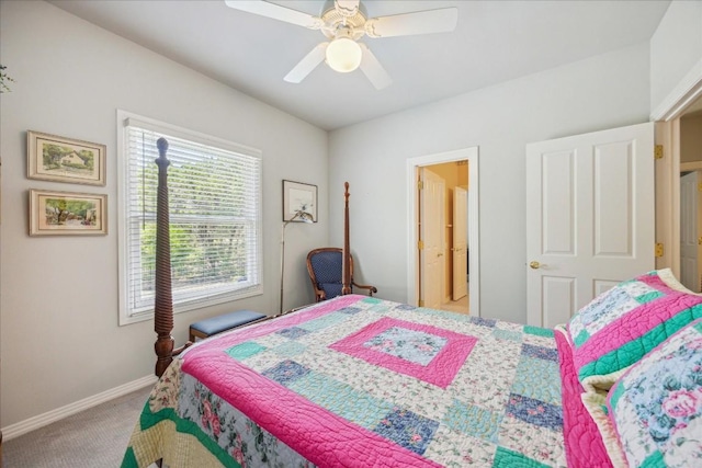 carpeted bedroom featuring baseboards and a ceiling fan