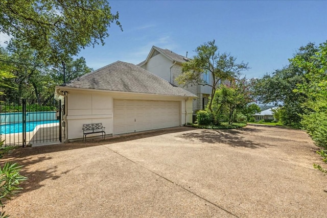 garage featuring a fenced in pool and fence