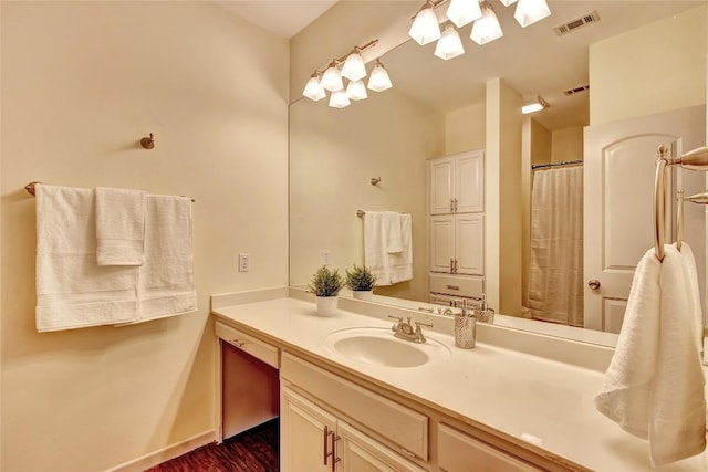 2208 Trailside Dr, Austin, TX 78704 - full bath featuring baseboards, visible vents, wood finished floors, and vanity