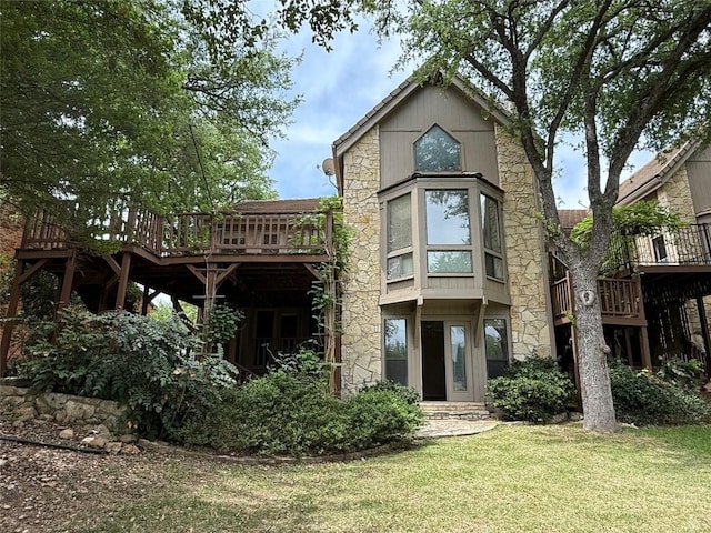 rear view of property with a yard and a deck