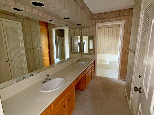 full bathroom featuring a sink, a bath, and wallpapered walls