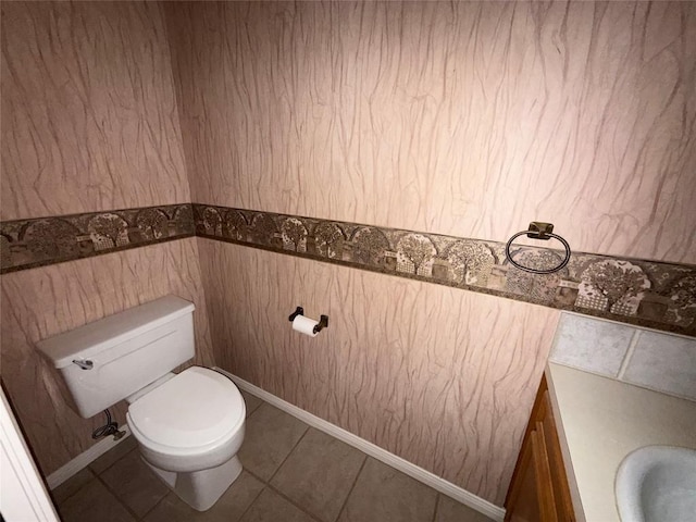 half bathroom featuring toilet and tile patterned flooring