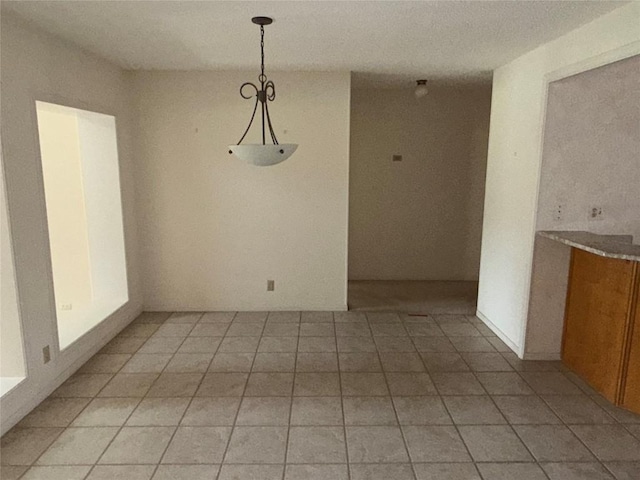 unfurnished dining area featuring light tile patterned floors