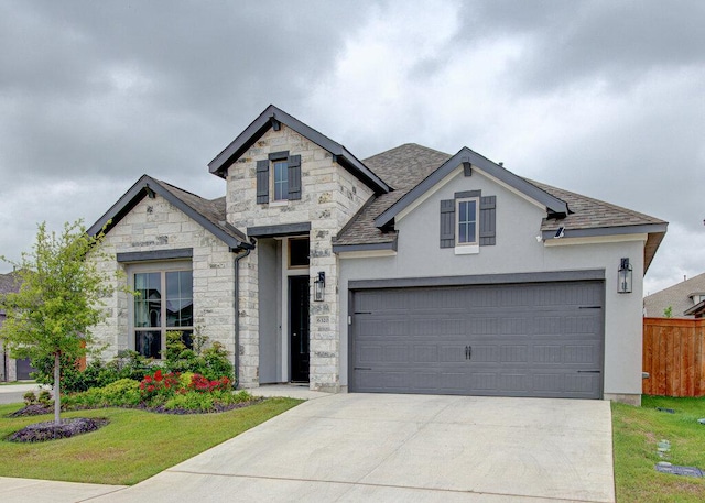 6320 Lipan Bayou Trl, Austin, TX 78738 - french provincial home featuring stone siding, concrete driveway, stucco siding, and roof with shingles