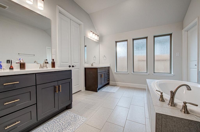 6320 Lipan Bayou Trl, Austin, TX 78738 - full bathroom with vaulted ceiling, two vanities, a garden tub, and tile patterned flooring
