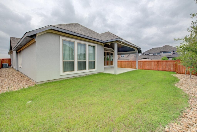 6320 Lipan Bayou Trl, Austin, TX 78738 - rear view of property featuring a fenced backyard, a patio, a shingled roof, and stucco siding