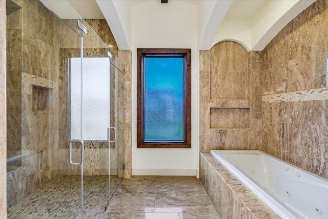 full bathroom featuring a stall shower and a tub with jets