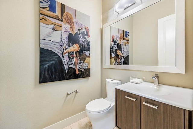 half bathroom with toilet, vanity, baseboards, and tile patterned floors