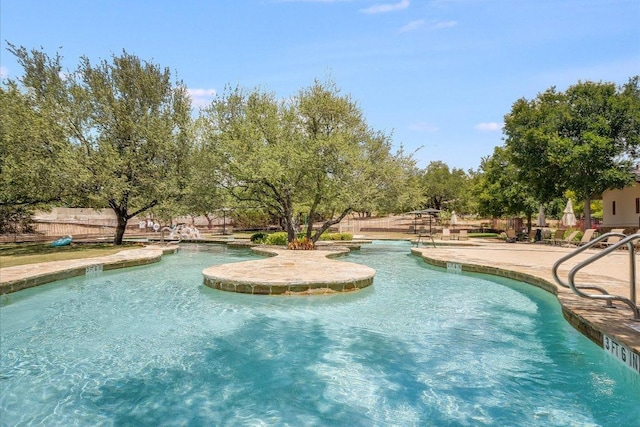 community pool featuring a patio area and fence