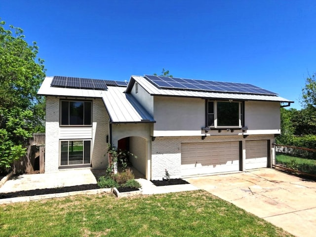 9010 Quail Creek Dr, Austin, TX 78758 - view of front of property with a standing seam roof, brick siding, a garage, and fence