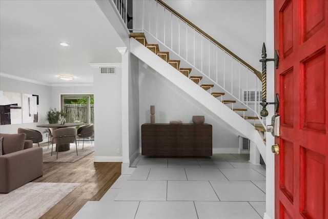 9010 Quail Creek Dr, Austin, TX 78758 - entryway with stairway, crown molding, baseboards, and visible vents